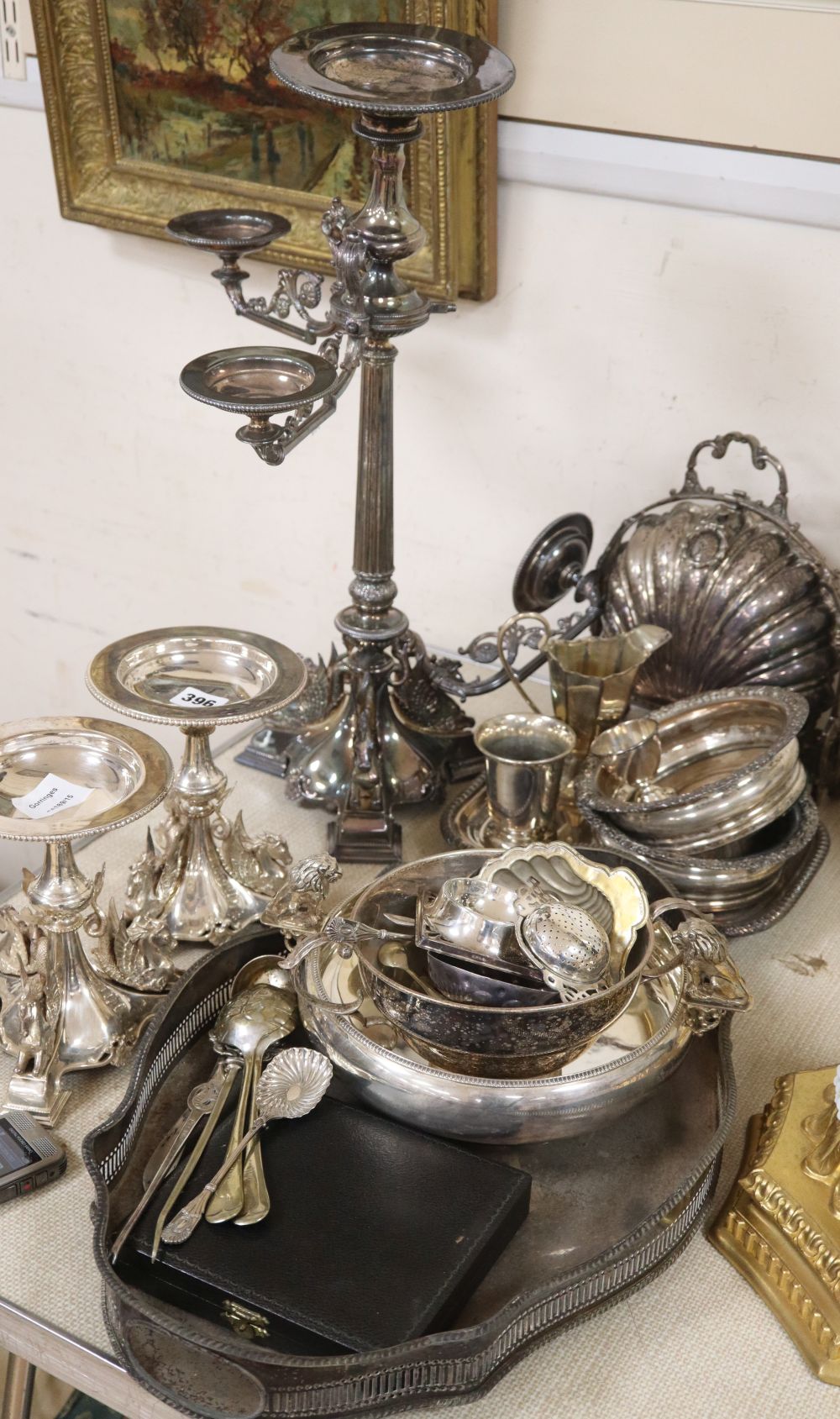 A collection of silver plate including a three branch four light candelabra, two smaller candlesticks, etc.